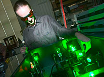 Matthew Pelton of Argonnes Center for Nanoscale Materials adjusts a green laser used to monitor the sporadic blinking of quantum dots.