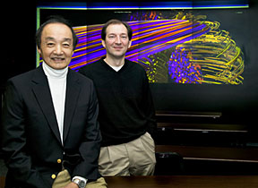 PPPL Chief Scientist Bill Tang (left) and PPPL computational scientist Stephane Ethier are at the Labs High-Resolution Wall. In the background is a plasma turbulence simulation.