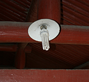 A compact fluorescent lamp, or CFL, lights an ancient temple outside of Ningbo, China. Compact fluorescents are an example of a technology used to increase building energy efficiency.