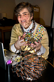 Vivian Stojanoff holds a model of the protein Lysozyme found in egg whites. A model of a silicon crystal is on the table, and an amethyst crystal sits on top of a silicon rod.