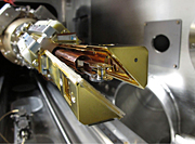 The NIF target is mounted in the cryogenic target positioning device. The two copper-colored arms form a shroud around the cold target to protect it until they open five seconds before a shot.
