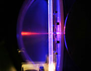 Laser light illuminates the chemical reactor tube in the Multiplexed Photoionization Mass Spectrometer, a unique tool for the study of isomer-resolved chemical reactions. Photo credit: David Osborn, Sandia National Laboratories.
