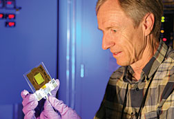Meiring Nortier examines a thorium target foil.