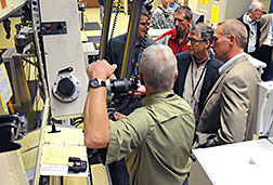 Bill Gates (in glasses) views a containment box in the Hot Fuel Examination Facility at Idaho National Laboratory.