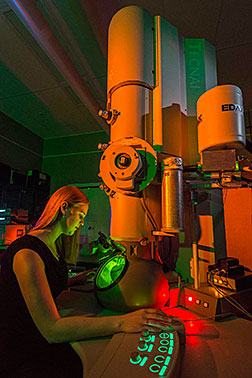 Katie Jungjohann at work on the Center for Integrated Nanotechnology’s transmission electron microscope. CINT is a user facility operated by Sandia and Los Alamos national laboratories for the Department of Energy’s Office of Science. (Photo by Randy Montoya)