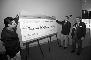 ORNL's Budhendra Bhaduri (left) and Jeff Wadsworth presented a tsunami relief check to Tony Farris of the American Red Cross during ceremonies at the RSC.
