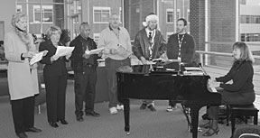 Carolers at the December 1 Club ORNL holiday gathering include (from left) Marilyn McLaughlin, Bonnie Hébert, Leroy Sims, Joe Inger, Sean Ahern, Steven Carter and pianist Beverly Kerr.