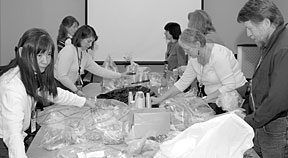 Volunteers prepare kits for K-2 students.