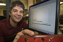 Brookhaven physicist Aleksey Bolotnikov demonstrates cadmium zinc telluride crystals at various steps in radiation detector fabrication. The tall, narrow peak in the spectrum on the computer screen is an indicator of the detectors superior performance. 