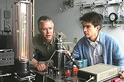 Chris Shaddix, left, and Alejandro Molina discuss an experiment to determine the best proportion of oxygen and CO2 for oxy-combustion of coal. Molina's small-scale experiments have established the groundwork to bring two other larger CRF (Combustion Research Facility) reactors into the research.