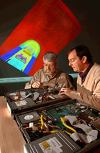 CYBERSPACE DOOR — Lyndon Pierson (left) and Perry Robertson examine their group's video encoder and decoder.