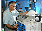 Researcher Devinder Mahajan uses a gas chromatograph to analyze carbon monoxide levels in hydrogen purified using his patented process.