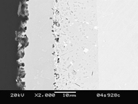 Electron micrograph of a 316 stainless steel coupon in cross-section shows the reaction layers. From left: 1) Aluminum oxide outer layer, 2) FeAl layer, 3) Fe3Al inner layer, and 4) 316SS.