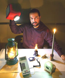 Berkeley Lab�s Evan Mills holds a prototype white light-emitting diode.