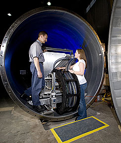 Daniel Maierhafer and Katherine Atchley, research associates in the Neutron Scattering Sciences Division at Oak Ridge National Laboratory, examine one of the small angle neutron scattering tanks recently installed at the High Flux isotope Reactor where cold neutrons will be produced for advanced materials studies.
