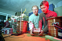 Dr. Jim O'Brien, left and Dr. Carl Stoots holding a ten-cell high temperature electrolysis stack.