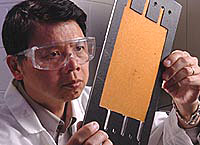 Argonne's Yupo Lin inspects the resin wafer in a gasket before loading it into the bioreactor.