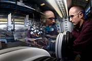 NREL scientist Robert Tenant manipulates an ink-jet sprayer in a glove box. Tenant is incorporating thin-film design and manufacturing processes to improve the performance and lower the cost of dynamic windows. 