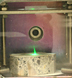 Laser light plays across a piece of cement spiked with chemical agent, creating a green “flame” of vapors and surface plasma.