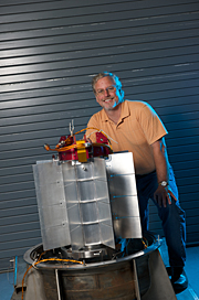 Steve Johnson, director of the INL Space Nuclear Systems and Technology Division, with the Multi-Mission Radioisotope Thermoelectric Generator that will power the 2011 Mars Scientific Laboratory mission.