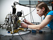 SIMES graduate student Julie Bert, the paper’s first author, adjusts imaging equipment used to make the discovery.