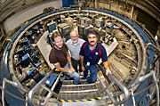Don Von Lintig, Bill Morse, and John Benante standing inside the muon g-2 storage ring at Brookhaven Lab.