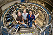 Don Von Lintig, Bill Morse, and John Benante standing inside the muon g-2 storage ring at Brookhaven Lab.