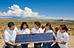 Sandra Begay-Campbell (center) with interns Devin Dick, Tammie Allen, Gepetta Billie and Chelsea Chee at Sky City within the Pueblo of Acoma. Begay-Campbell is describing how a photovoltaic panel works to generate electricity. (Photo by Randy Montoya)