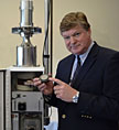 LLNL's Steve Homann, who served as DOE's senior science adviser for the NASA Mars Science Laboratory mission, holds a filter for an Environmental Continuous Air Monitor (shown in the background).