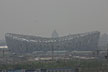 High smog levels, seen here during the stadium's construction, were a concern before the Olympic Games in Beijing in 2008. Regional weather patterns and emission controls reduced smog levels at the Olympic Games. Photo courtesy of Ry Tweedie-Cullen.