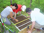From  left, ORNL's Joanne Childs, Colleen Iversen and Rich Norby dig soil pits and excavate roots and soil at the FACE site.