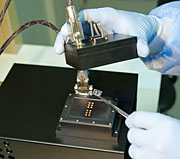A researcher loads a sample into Lawrence Livermore National Laboratory's new fast polymerase chain reaction (PCR) instrument.