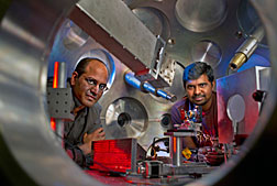 Sasi Palaniyappan (right) and Rahul Shah (left) inside a target chamber where the TRIDENT short pulse laser is aimed at a very thin foil target.