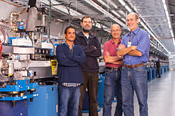 Part of the SLAC team that worked on self-seeding is shown alongside the hardware in the LCLS Undulator Hall. From left: John Amann, Henrik Loos, Jerry Hastings and Jim Welch. Photo by Matt Beardsley, SLAC National Accelerator Laboratory 