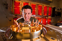Sandia researcher Ryan McBride pays close attention to the tiny central beryllium liner to be imploded by the powerful magnetic field generated by Sandia’s Z machine. The larger cylinders forming a circle on the exterior of the base plate measure Z’s load current by picking up the generated magnetic field. (Photo by Randy Montoya)
