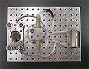 The schematic of a vacuum compatible aqueous SIMS device. Insert shows the secondary H- and Si- ion images of this aperture.