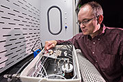 Sandia Labs researcher Chris Brotherton checks tiny sensors in a test fixture, where he exposes them to different environments and measures their response to see how they perform. Brotherton is principal investigator on a project aimed at detecting a common type of homemade explosive made with hydrogen peroxide. (Photo by Randy Montoya)