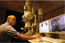 Ames Lab scientist Matt Kramer operates the Lab’s transmission electron microscope. Various equipment options allow scientists to probe different aspects of a material. In scanning mode, or scanning transmission electron microscopy (STEM), the electron beam is scanned back and forth across the sample.