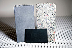 Three new products developed at Jefferson Lab for shielding against neutrons consist of a boron-rich paneling for use in space-restricted areas (front), boron-rich concrete that absorbs neutrons using less material (left), and a lightweight concrete that is four times better at slowing down neutrons than ordinary concrete (right).