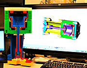A 3D printed version of a fast gas valve for the disruption mitigation system. The 3D design is shown on the computer screen in the background. Photo: US ITER A 3D printed version of a fast gas valve for the disruption mitigation system. The 3D design is shown on the computer screen in the background. Photo: US ITER (hi-res image)