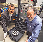 Physicists Alexander Glaser, left, and Robert Goldston display the non-nuclear test object that will serve as a target in their research.