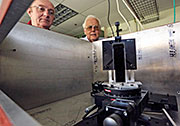 Kenneth Hill and Manfred Bitter inspect an X-ray crystal spectrometer to be used to study laser-produced plasmas. The vertically mounted silicon crystal has a thickness of 100 microns, about the average diameter of a human hair.