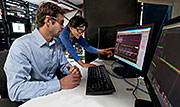 NREL engineers Greg Martin and Mariko Shirazi work on data capture for microgrid synchronization waveforms. American utilities are looking at smaller, flexible systems such as microgrids that can deliver electricity anywhere. Photo by Dennis Schroeder, NREL
