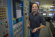 Dennis Perepelitsa in the PHENIX control room.