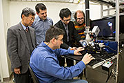 From left to right, Peter Liaw from University of Tennessee, Knoxville; Mikhail Feygenson and Louis Santodonato (seated) from ORNL; Yang Zhang from the University of Illinois at Urbana-Champaign; and Joerg Neuefeind from ORNL align a sample in the sample levitator, which was used in their experiment to study high entropy alloys.