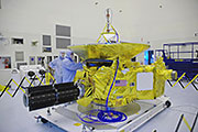The radioisotope thermoelectric generator (black) undergoing testing during the "hot fit check" in November 2005 prior to the January 2006 launch, courtesy of NASA.