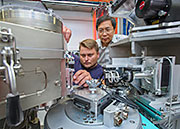 Dima Bolmatov and NSLS-II IXS beamline group leader Yong Cai making adjustments at the beamline experimental end station.