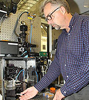 LLNL optical engineer Bryan Moran makes an adjustment to the Large Area Projection Micro Stereolithography machine, for which he recently received a 2015 Federal Laboratory Consortium (FLC) Far West Region Award for outstanding technology development. Photo by Steve Wampler/LLNL