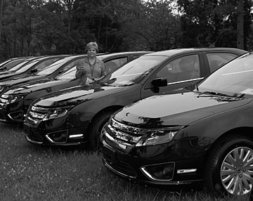 Fleet manager Kathye Settles with some of the new hybrid cars.