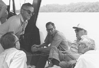Rep. Chet Holifield (second from right) on a visit to Oak Ridge. Among those who took him on a boat ride were ORNL Director Emeritus Alvin Weinberg (far right) and former Lab researcher Phil Hammond (upper left).